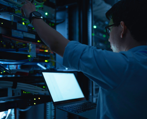 Computer engineer is setting up network in server room