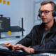 Male IT Support Agent Providing Professional Assistance to a Customer During a Live Support